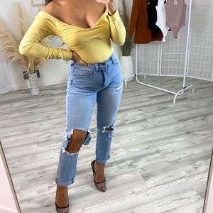 Yellow mustard colored body suit long sleeve and be worn off the shoulder